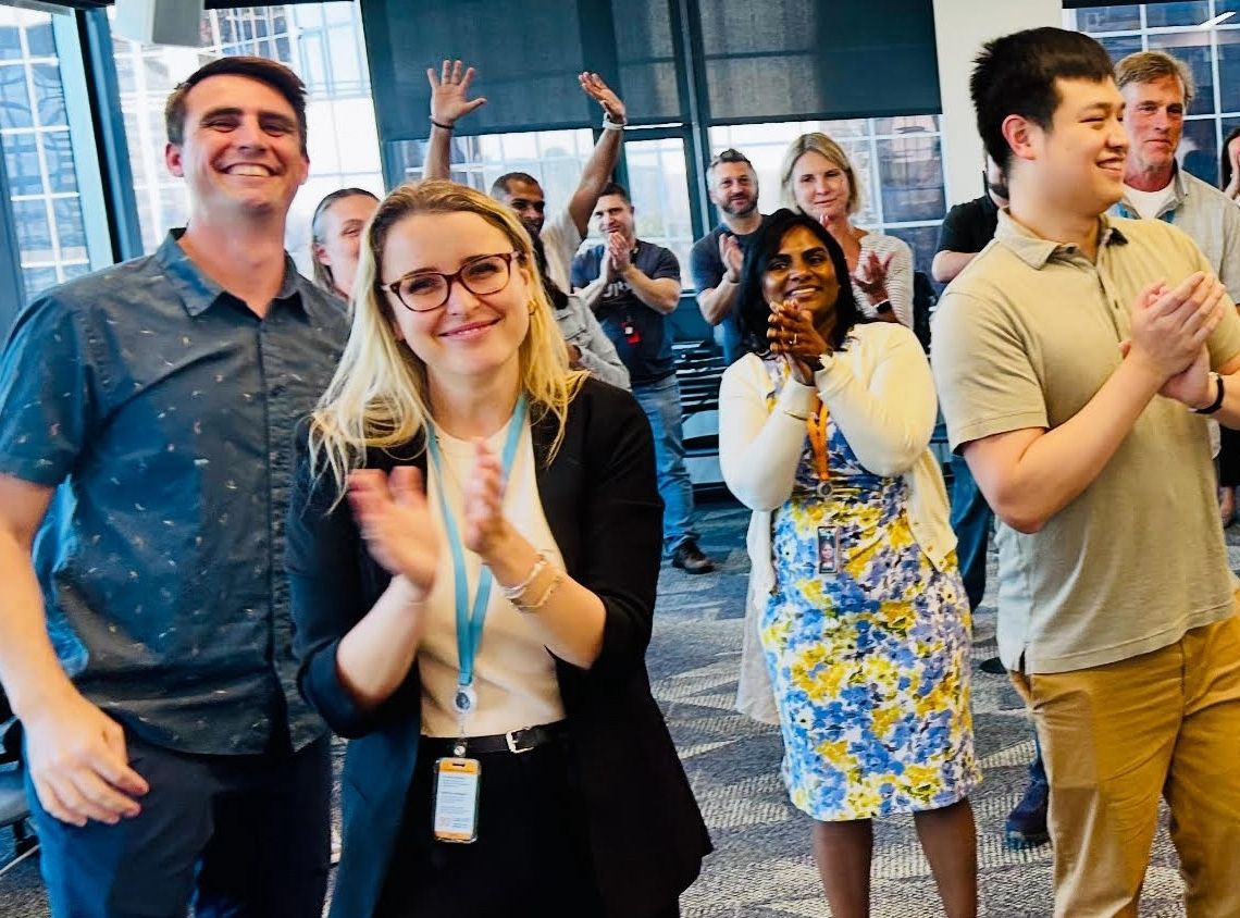 A diverse team celebrating together after an improv workshop