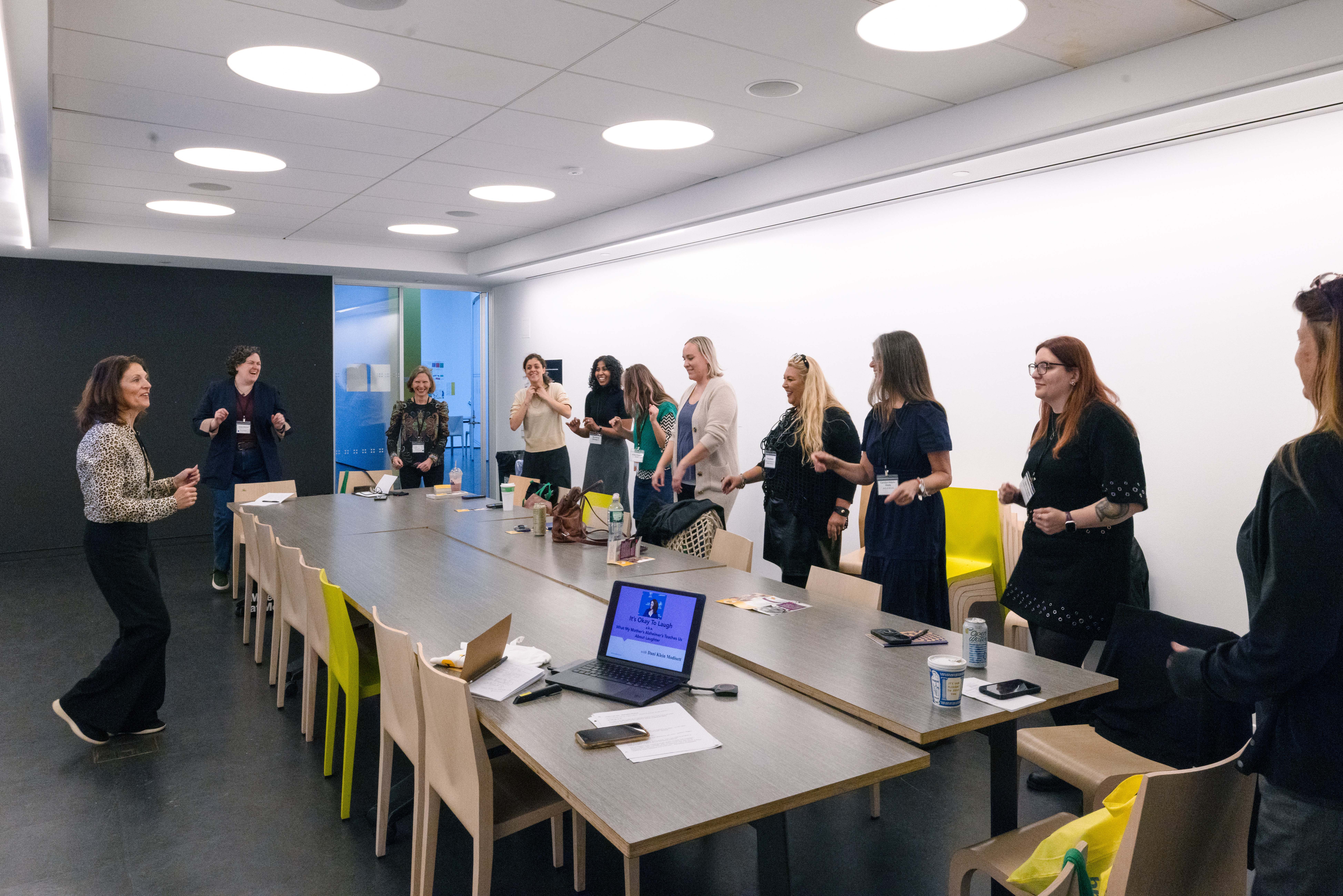 Colleagues gathered around a table during an interactive leadership workshop